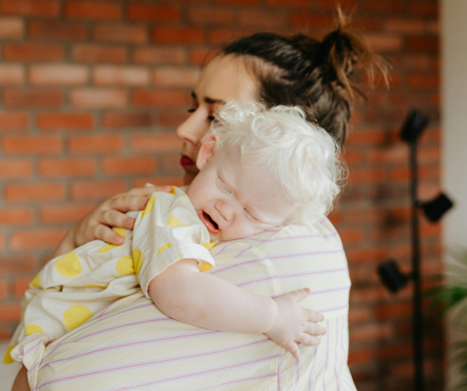 mom holding baby crying