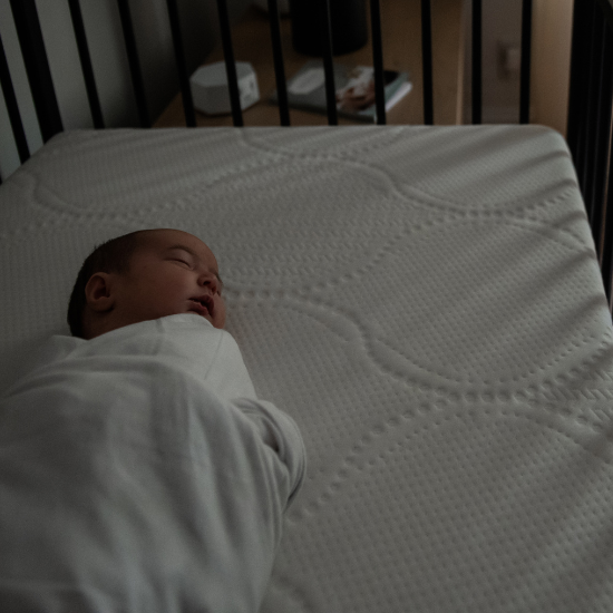 baby sleeping in dark room