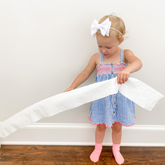toddler girl with toilet paper