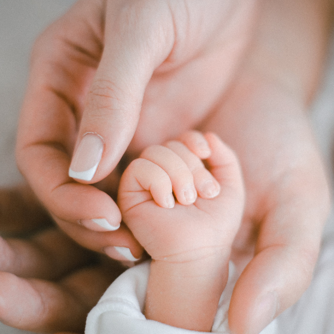mom holding baby's hand
