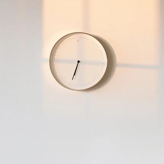 Clock on wall with early morning light