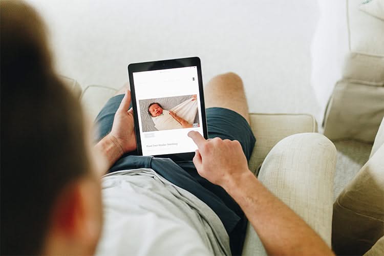 Man taking Moms on Call 0-6 month online course on a tablet