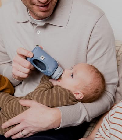 A father feeding his baby with a bottle
