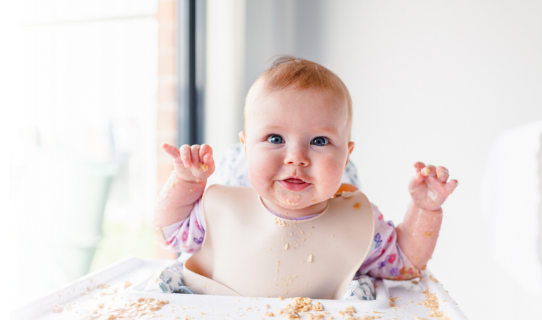 A happy baby after a solid meal