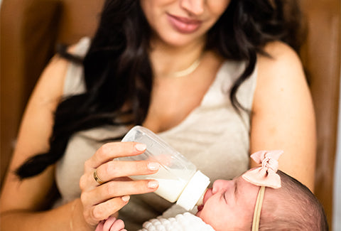 Mother feeding the baby with a bottle 7