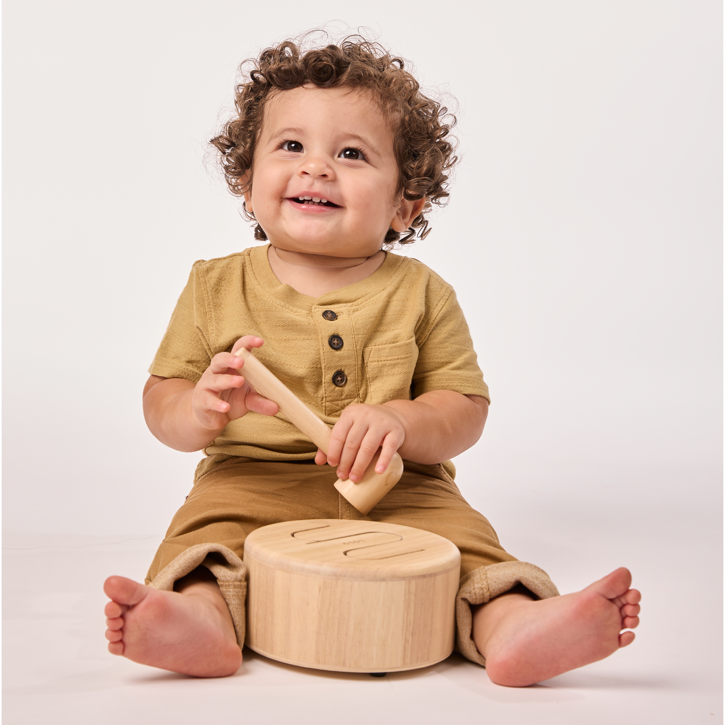 Child playing with wooden toys on a plain background