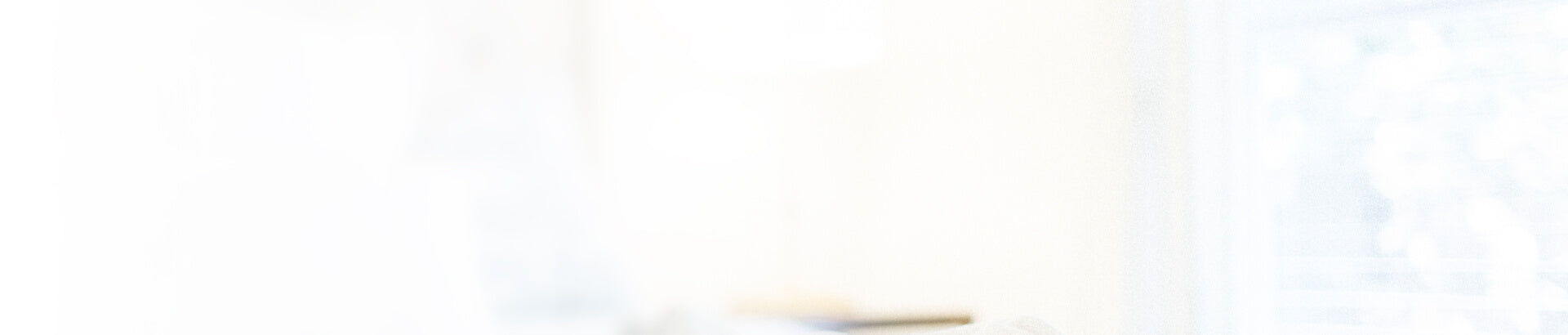 Blurred and overexposed view of a light indoor space