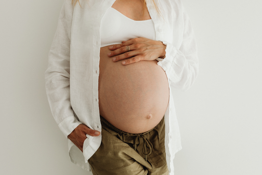 Woman holding her pregnant belly