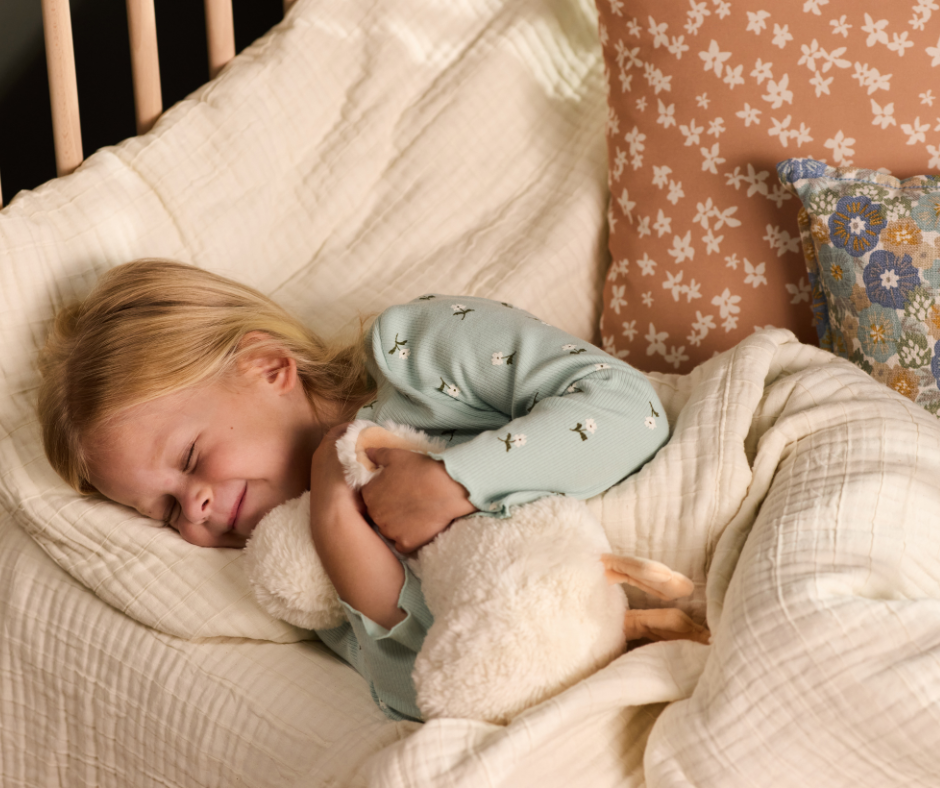 toddler sleeping in her toddler bed