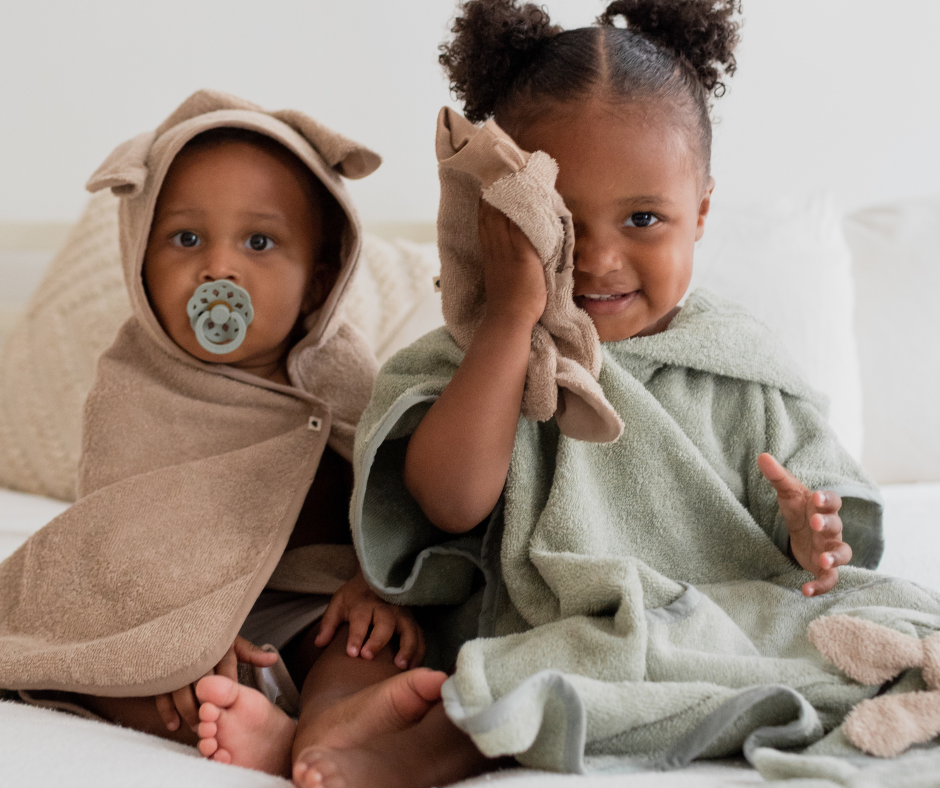 two toddlers at bath time