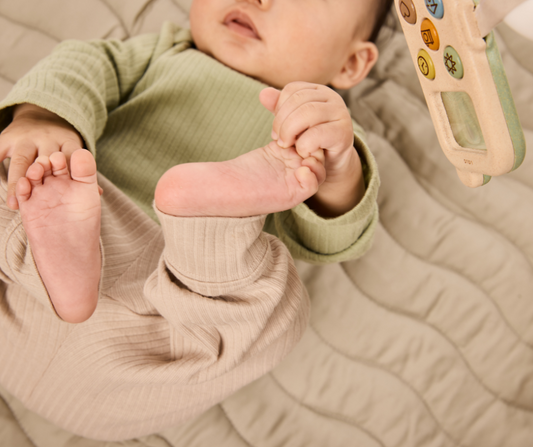 baby playing with toes