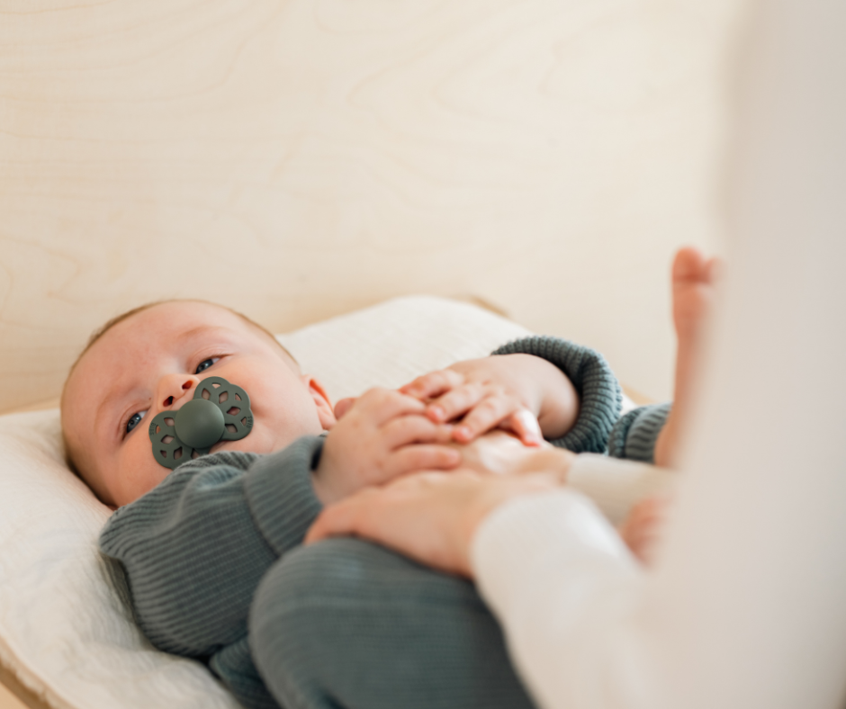 A baby with a bibs pacifier