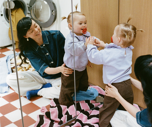 mom and toddler doing laundry