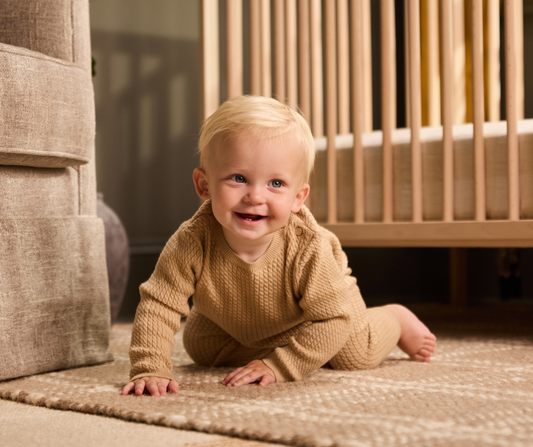 baby crawling in nursery