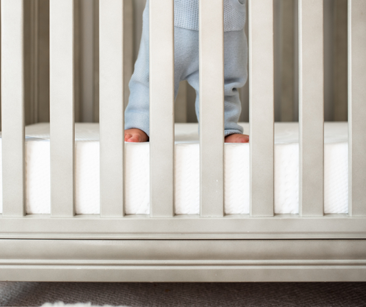 baby standing in crib