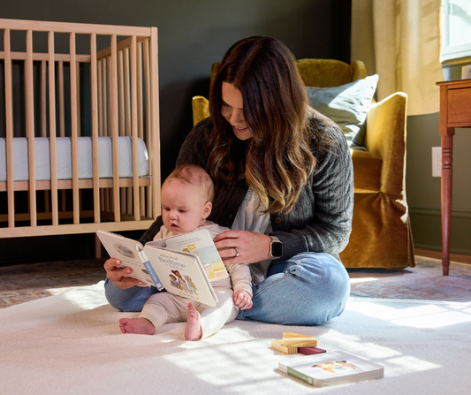 4 month old reading story with mom