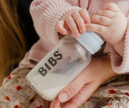 baby holding bottle