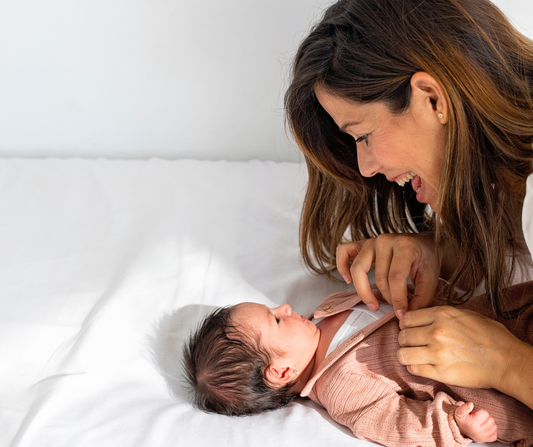 mom changing baby