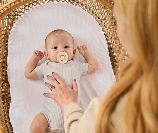 baby in bassinet prepping for sleep