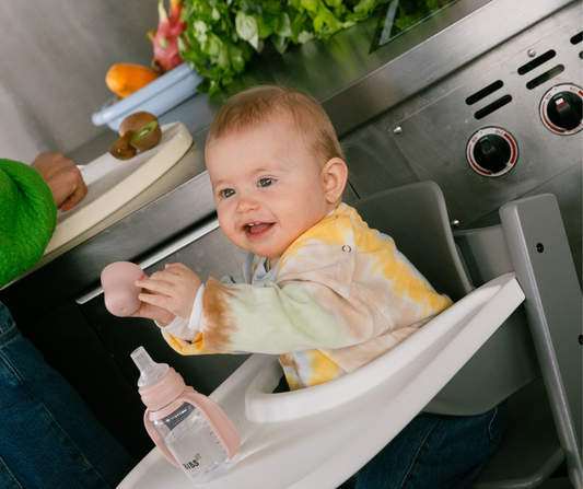 baby eating in high chair