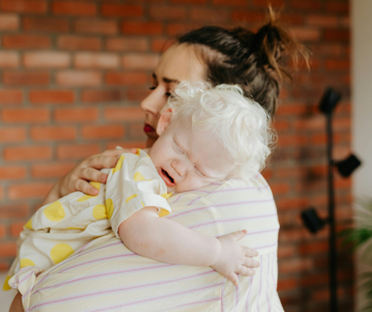 mom holding baby crying 