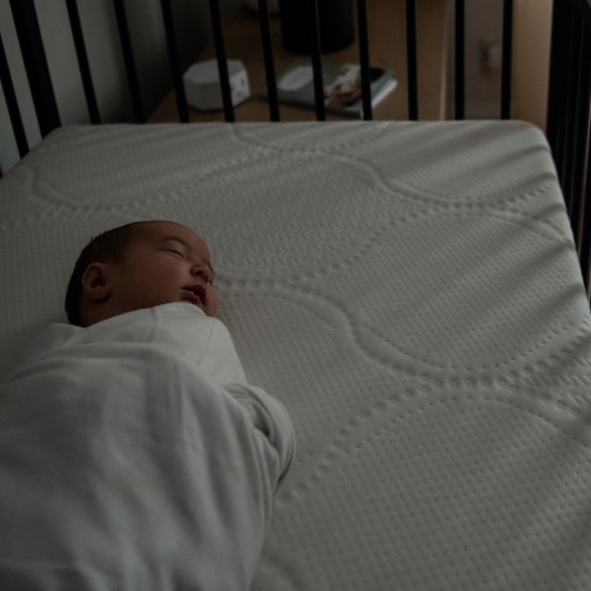 baby sleeping in dark room