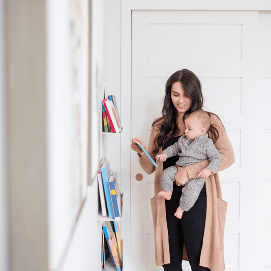 5 month old looking at book with mom