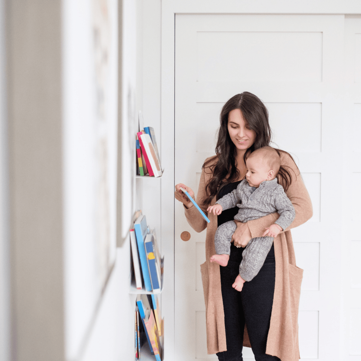5 month old looking at book with mom