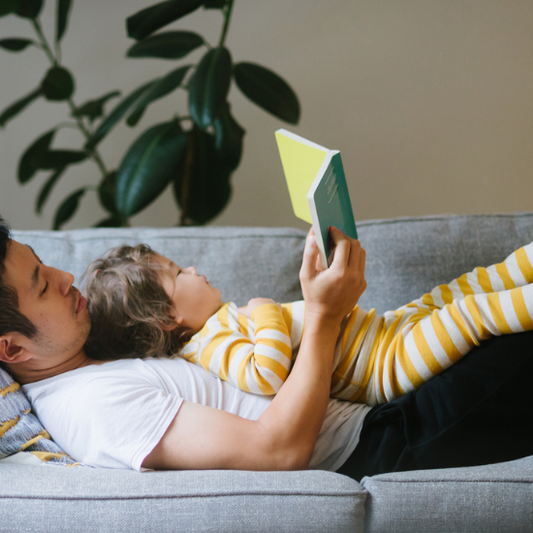 A dad reading to his toddler