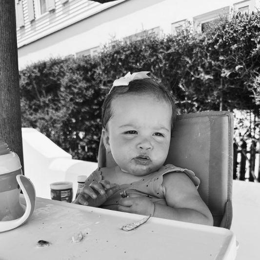 6-15 month old baby eating lunch with a sippy cup