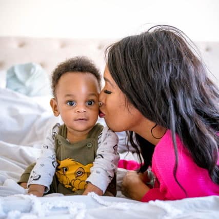 Mom kissing baby on the cheek