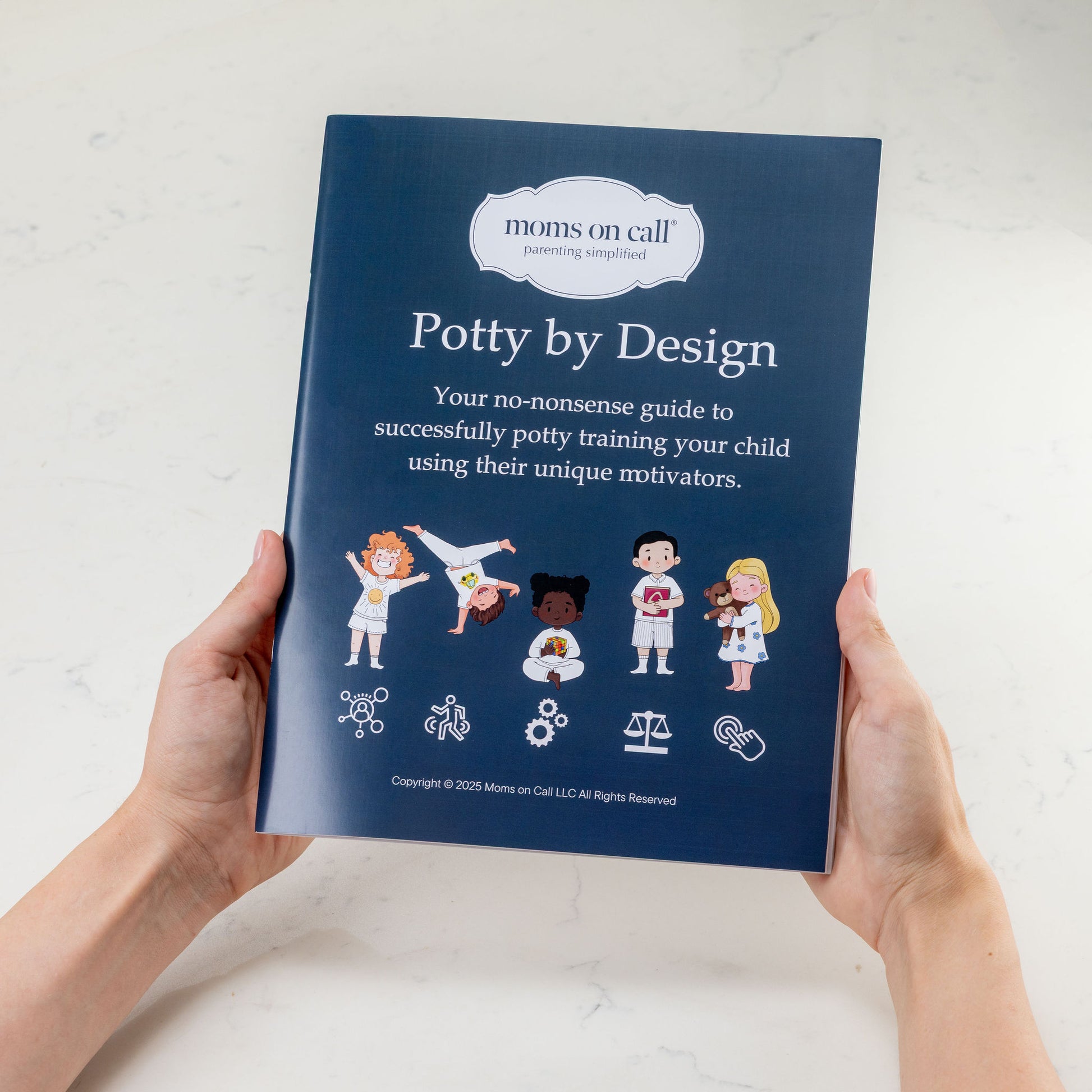 Book titled 'Potty by Design' held by hands on a light background